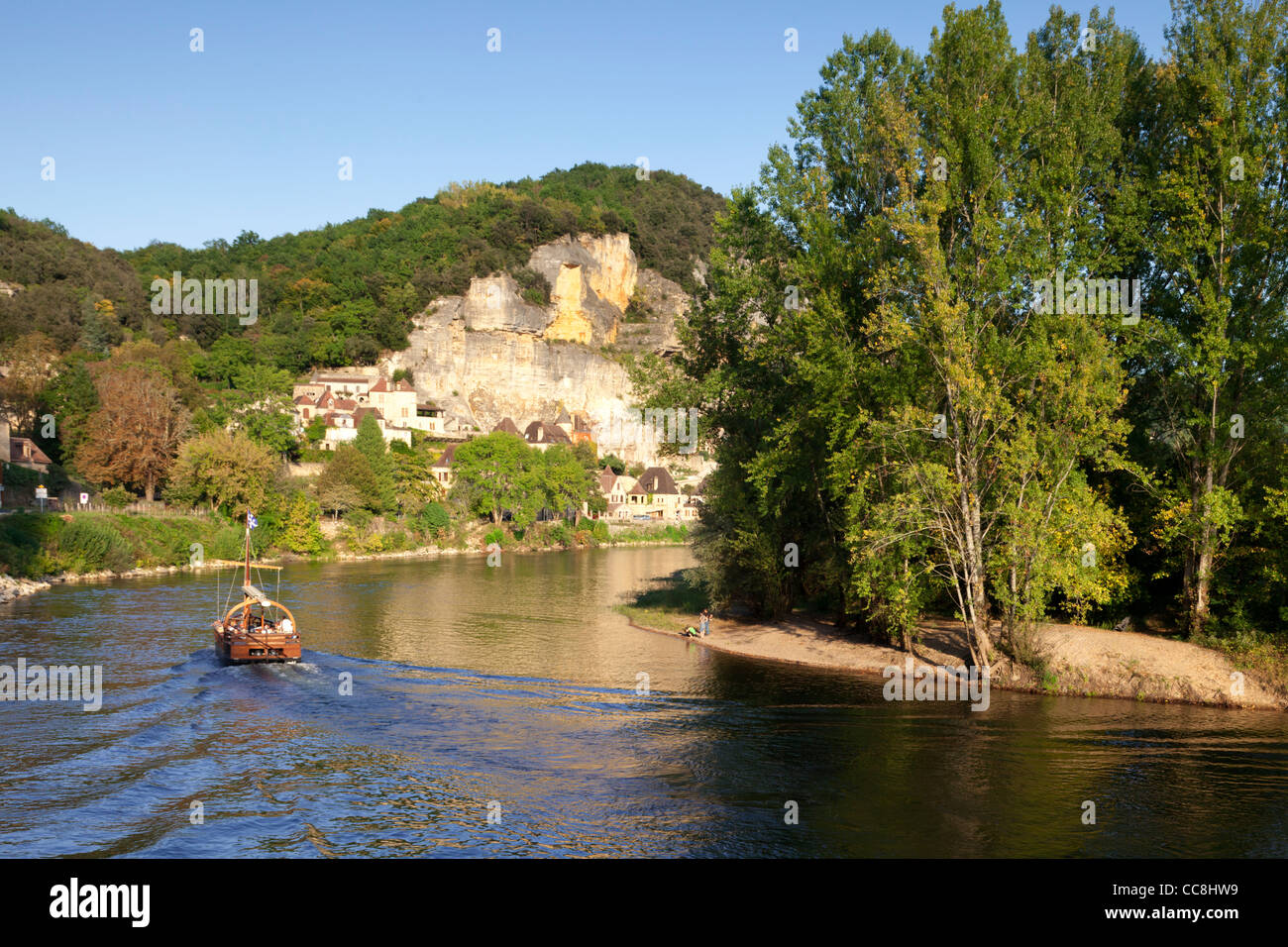 Nel tardo pomeriggio la luce sul fiume Dordogne, Aquitania, in Francia, come gabarre o battello fluviale, si avvicina La Roque-Gageac. Foto Stock