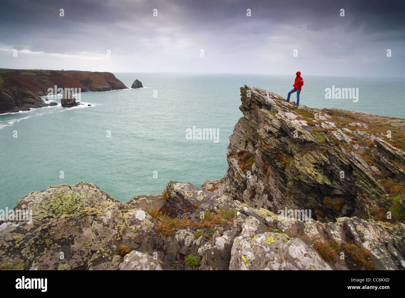 Un viandante si fermò sulla capezzagna a Boscastle in Cornwall, Regno Unito, guardando ad ovest lungo la costa verso Tintagel. Foto Stock