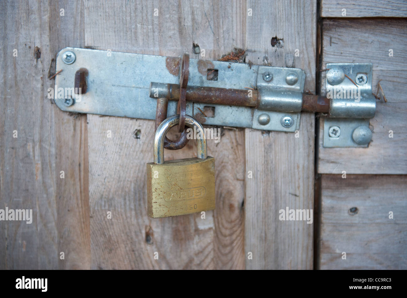 Bloccato il lucchetto in acciaio su una tettoia in legno Foto Stock