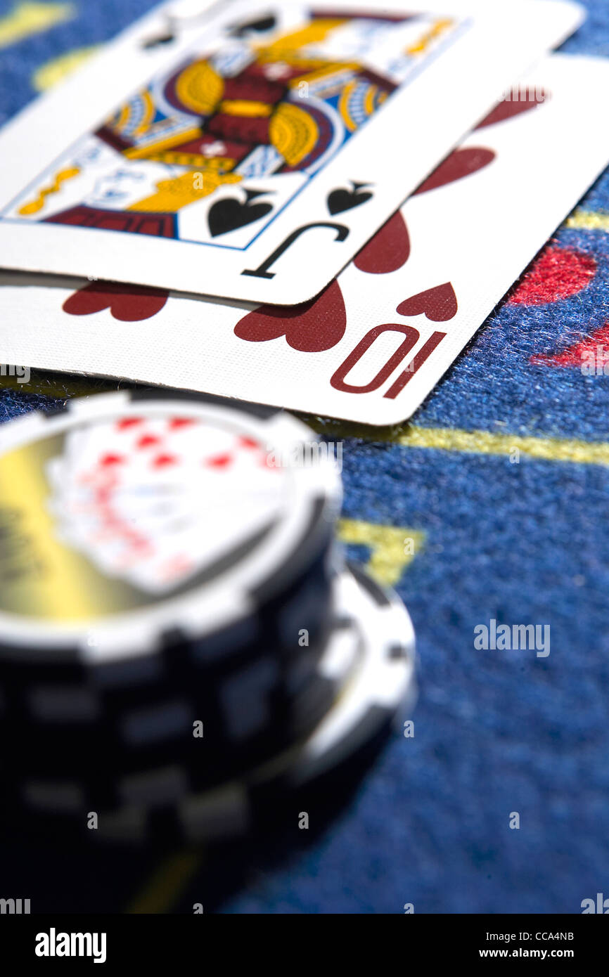Carte da gioco e i chip raffigurato su un tavolo da roulette in un centro città casinò. Foto Stock
