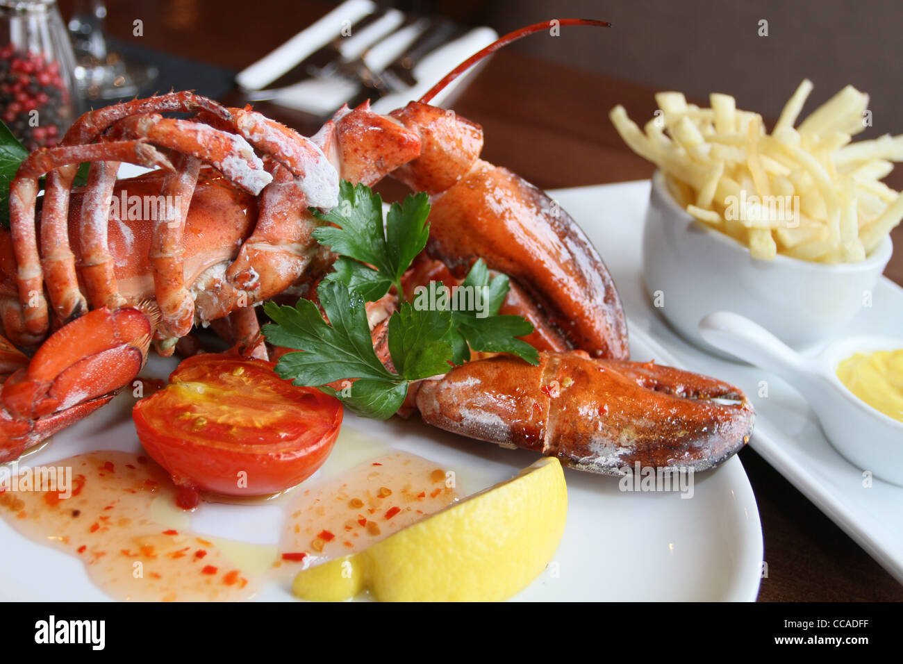 Astice al Vapore servito con patate fritte e senape Foto Stock