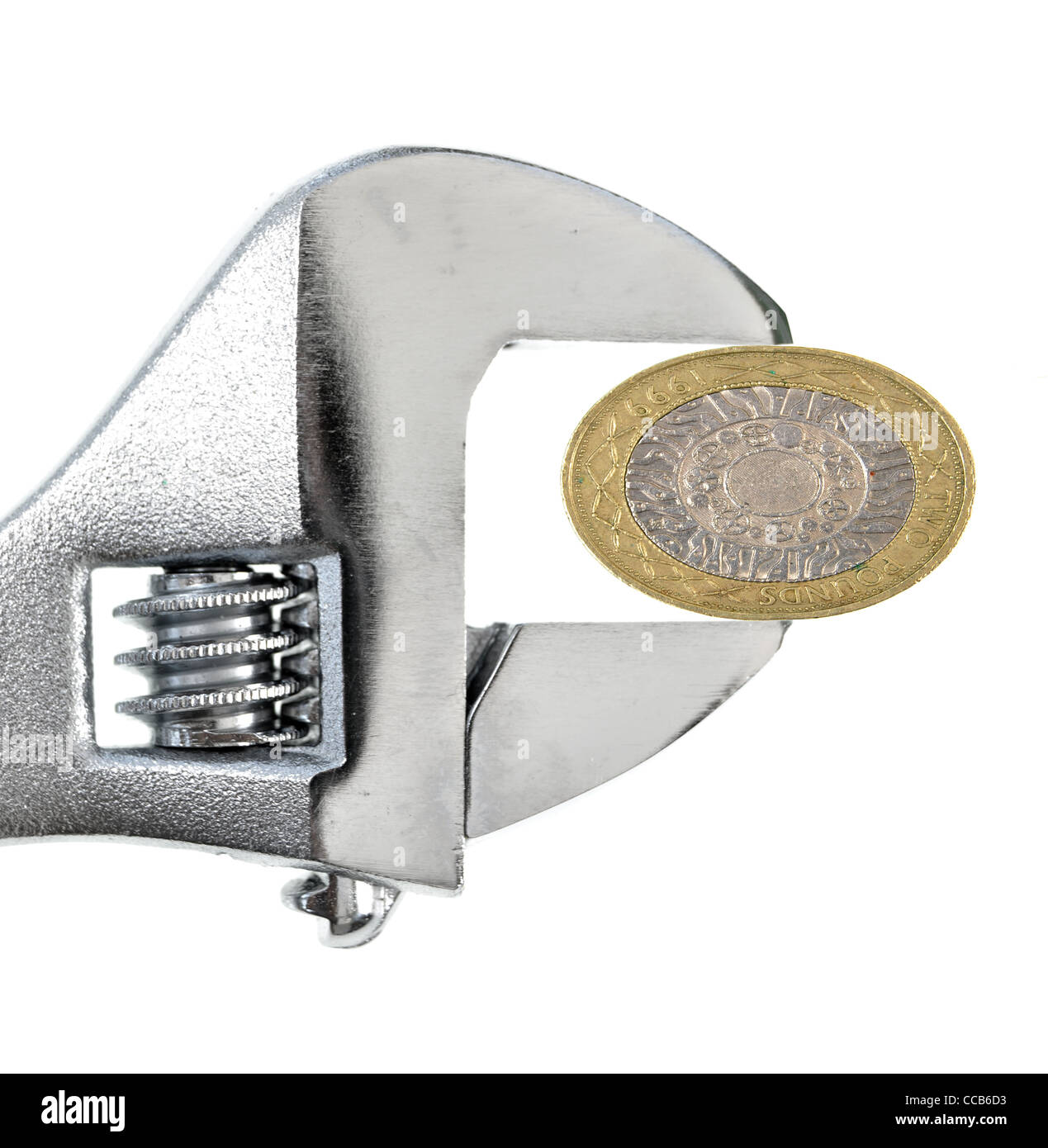 Coin che vengono schiacciati dalle pinze Foto Stock