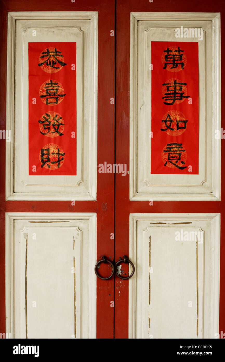Vecchie porte in legno con felice anno nuovo scritto in caratteri cinesi. Foto Stock