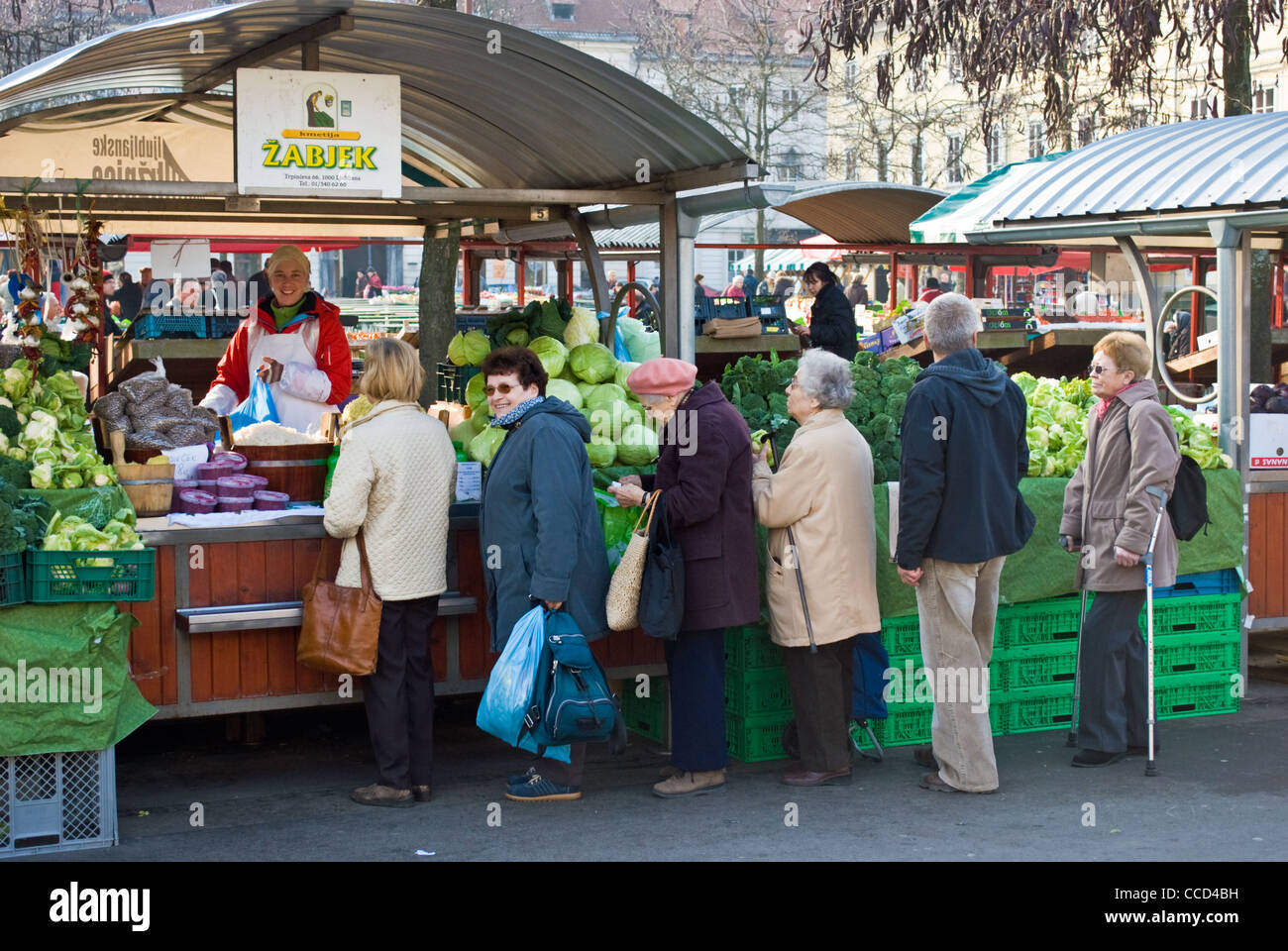 I clienti in coda per acquistare verdure al mercato centrale di Ljubljana, Slovenia. Foto Stock