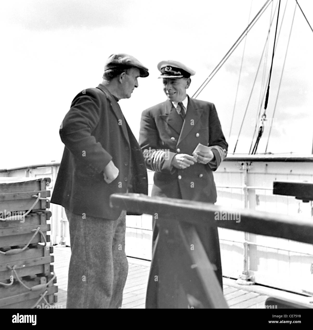 Islander Pat Hernon chat con Dun Angus skipper mentre è inserito in corrispondenza di Kilronan pier Inis Mor Isole Aran Co Galway, Irlanda Foto Stock