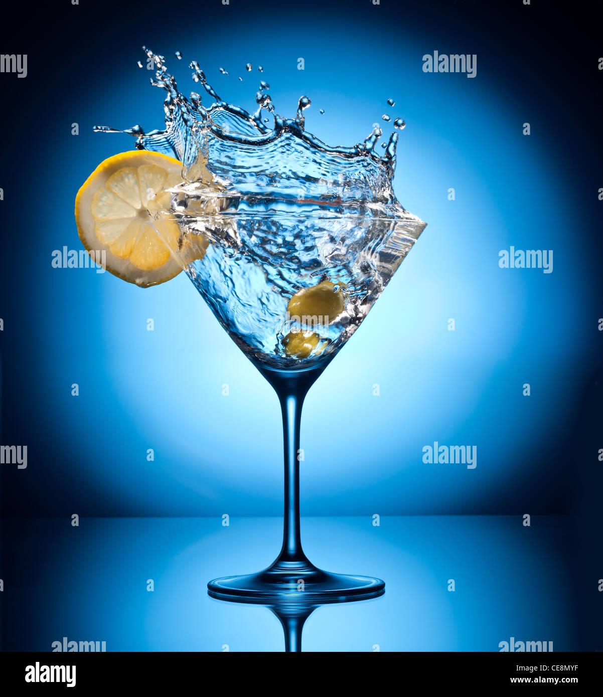 Splash martini da battenti olive. Oggetto su uno sfondo blu. Foto Stock
