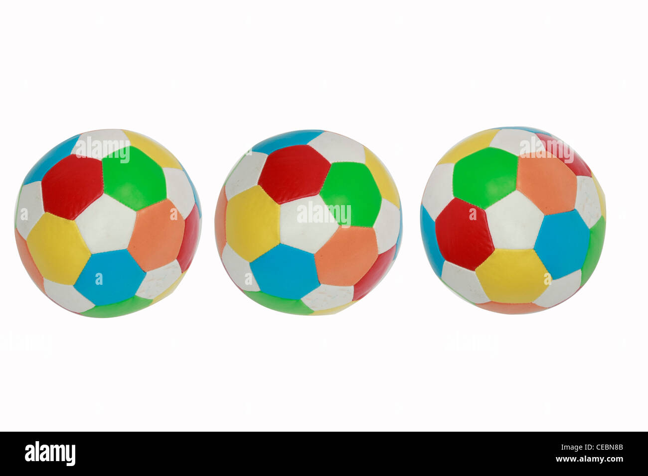 Tre sfere colorate mantenuta fianco a fianco Foto Stock