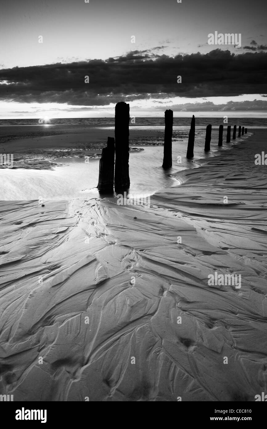 Tramonto a Brancaster beach in Norfolk, Inghilterra Foto Stock