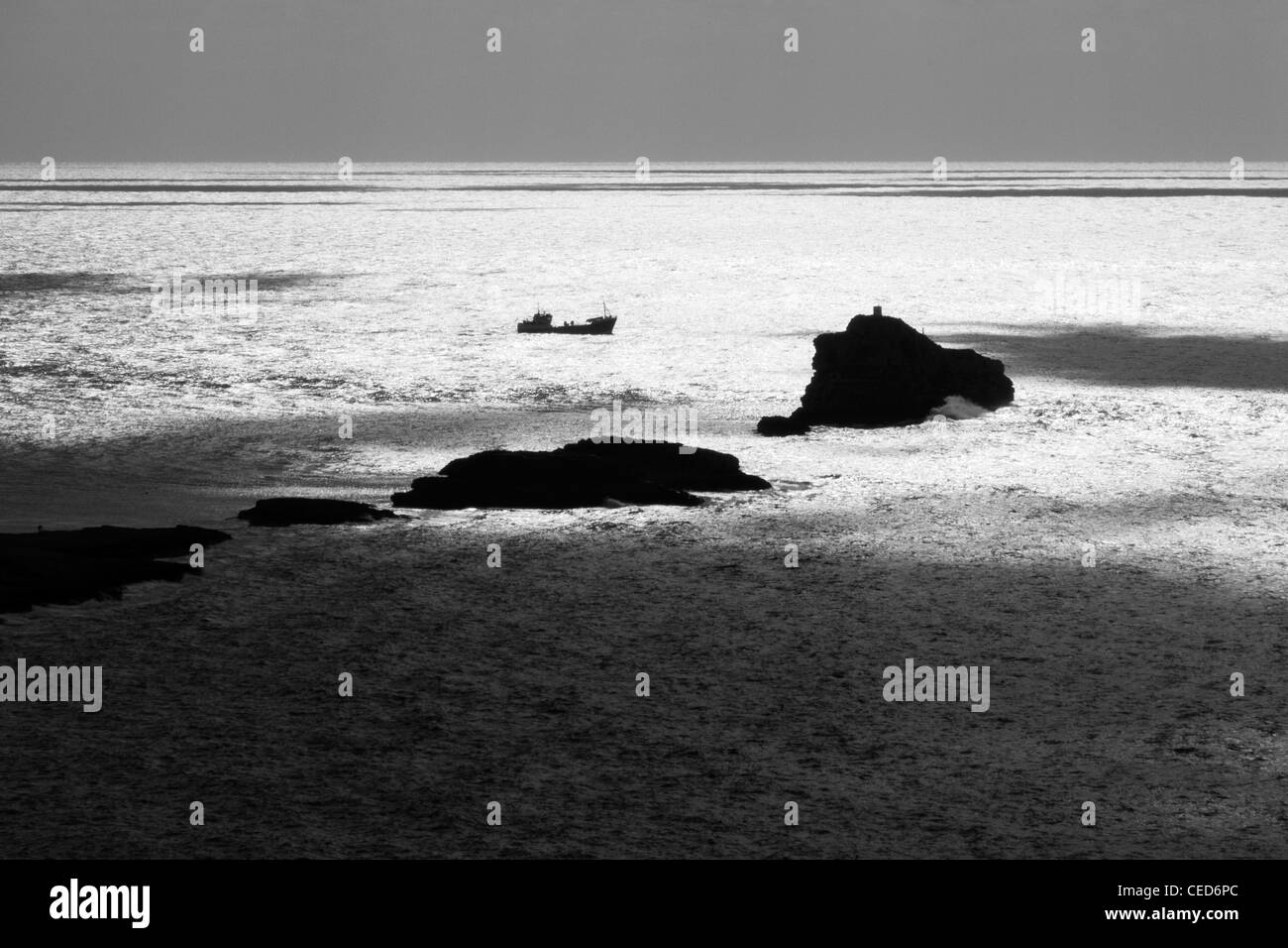 Lone nave le rocce su 'back light' come mare mediterraneo panoramica acqua argentea superficie Maiorca Maiorca Isole Baleari Spagna Foto Stock