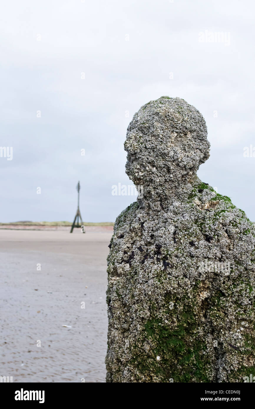 Anthony Gormley di uomini di ferro sculture " un altro posto' su crosby beach, Liverpool Merseyside Foto Stock