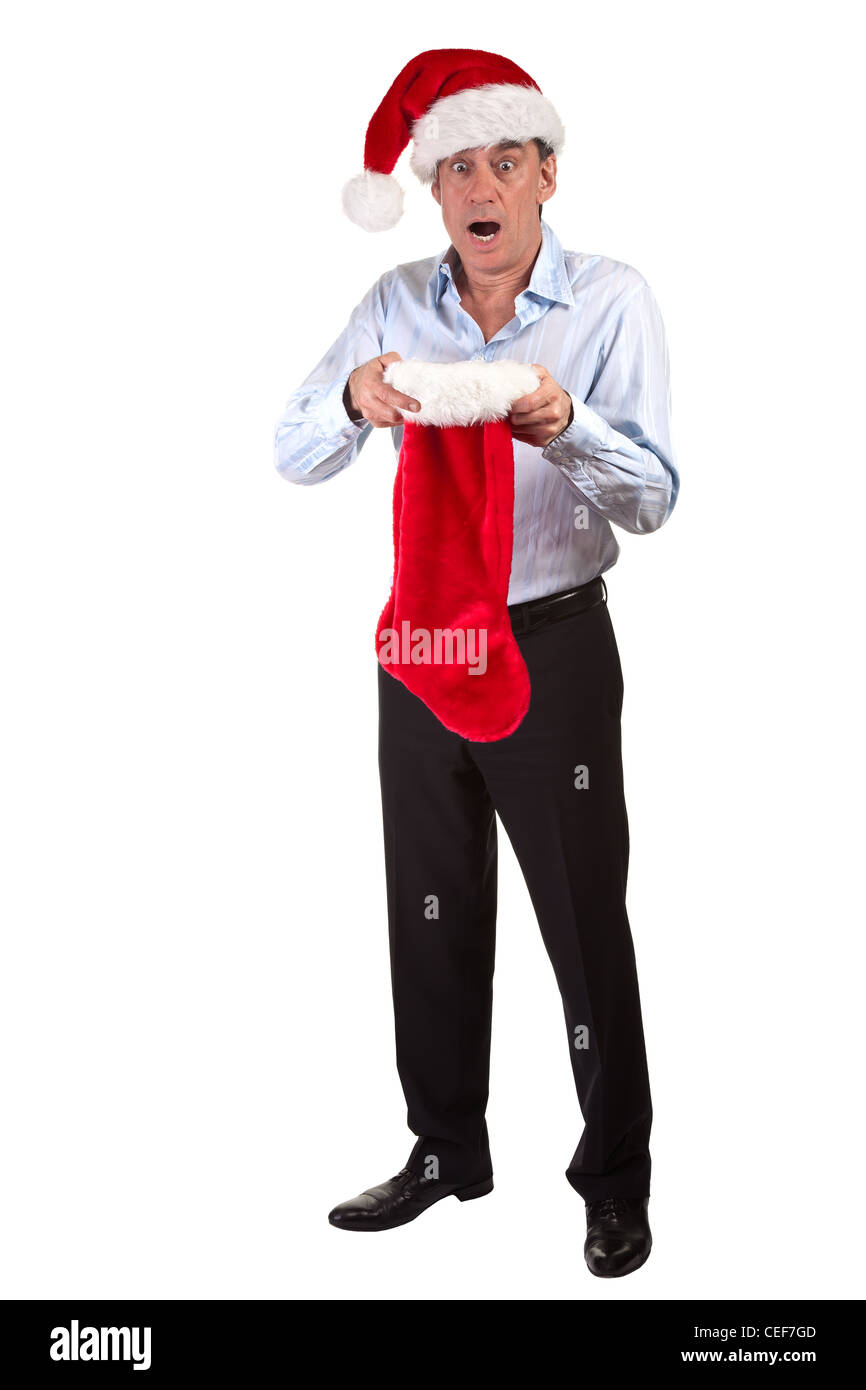 Business man in Santa Hat scioccato di contenuto della calza di Natale a piena lunghezza Ritratto Foto Stock