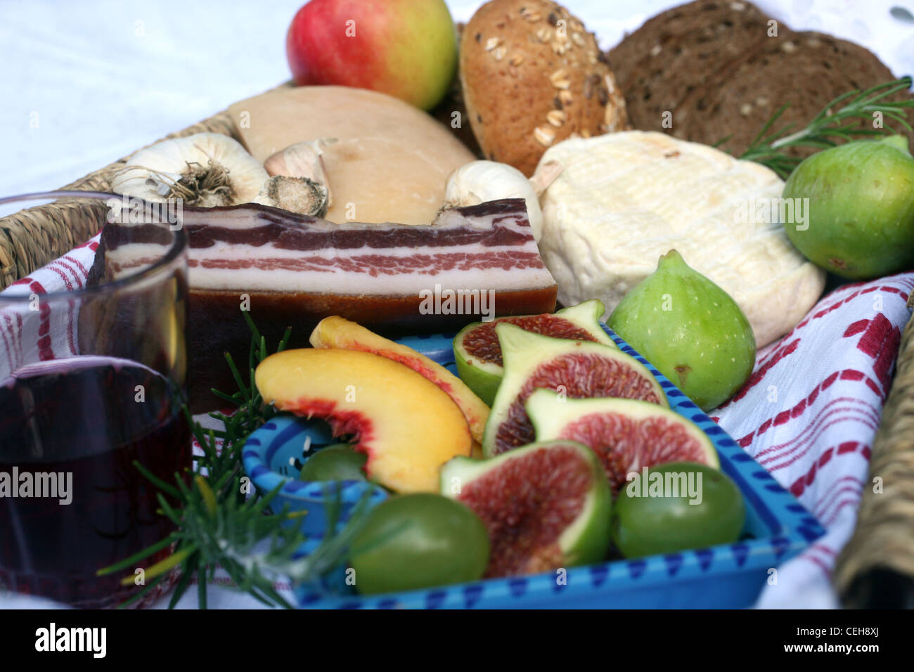 Rustico vita ancora di pane, formaggio, pancetta e figure in un cesto di vimini Foto Stock