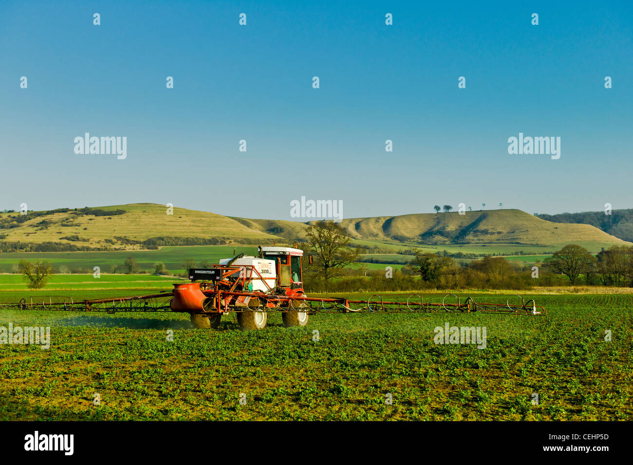 Irrorazione delle colture nel mese di febbraio in un campo inglese Foto Stock