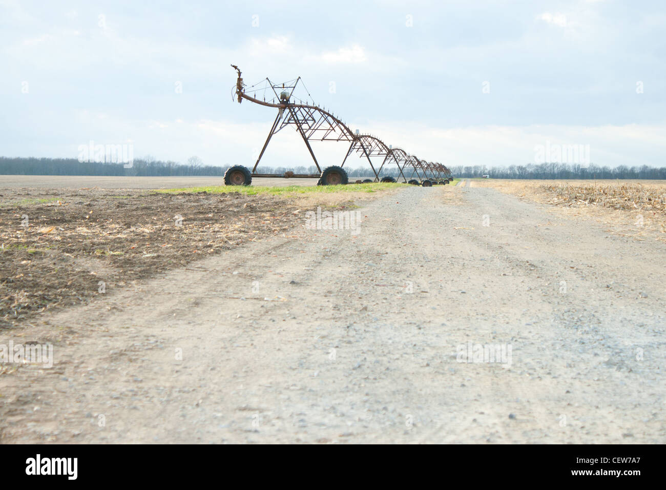 Mobile sistema di irrigazione fodera una strada sterrata in un campo impostazione Foto Stock