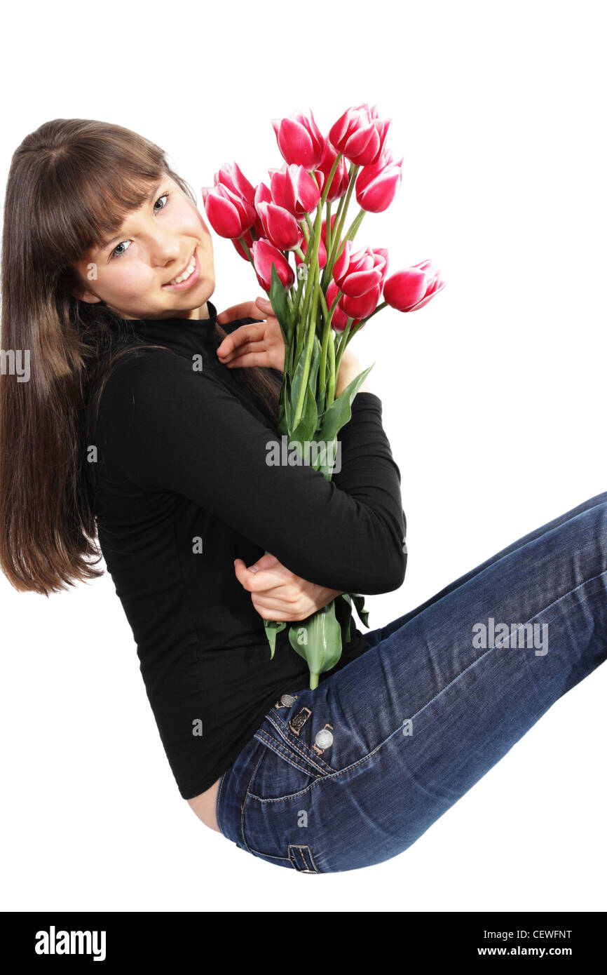 Sorridente ragazza con fiori su sfondo bianco Foto Stock