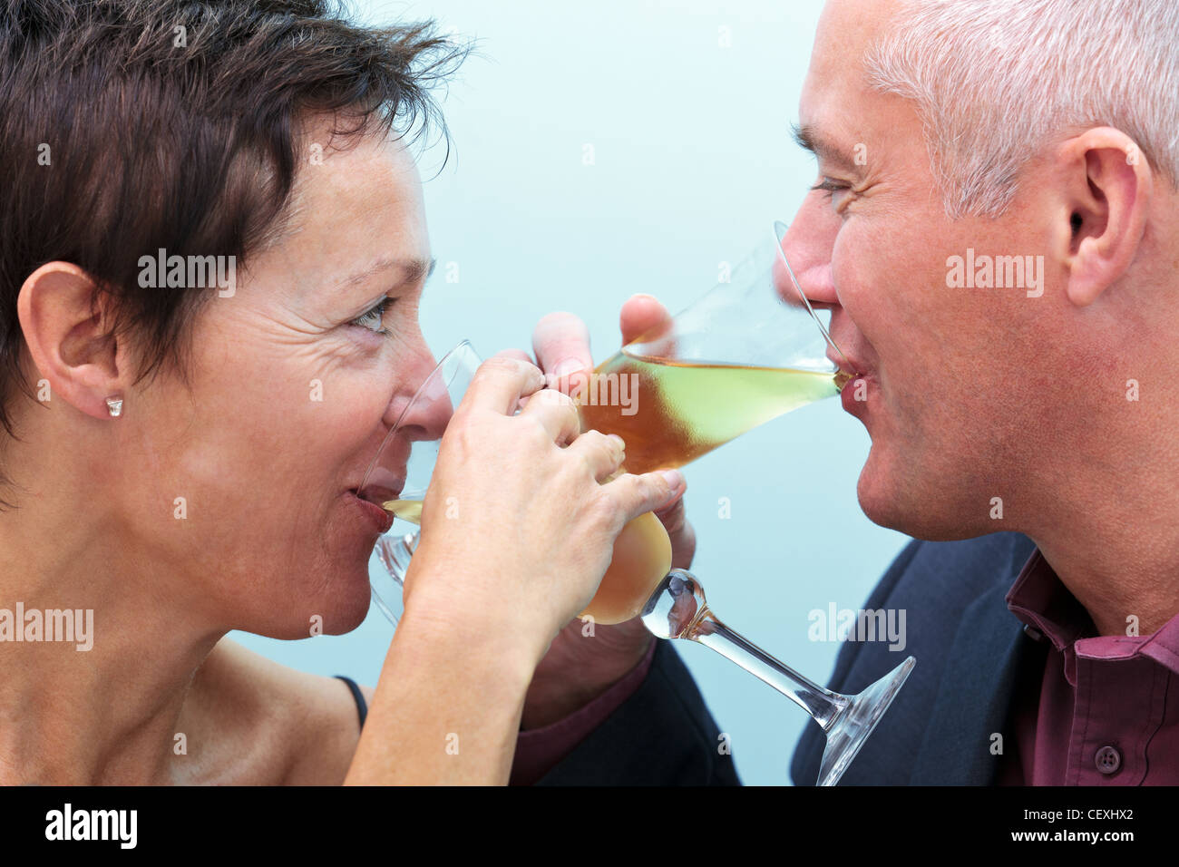 Foto di una matura coppia sposata bicchieri di champagne e cercando in ogni altri occhi. Foto Stock