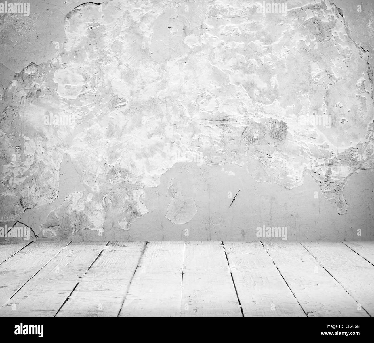 Vuoto interno della camera vintage di bianco muro di pietra e il vecchio pavimento in legno Foto Stock