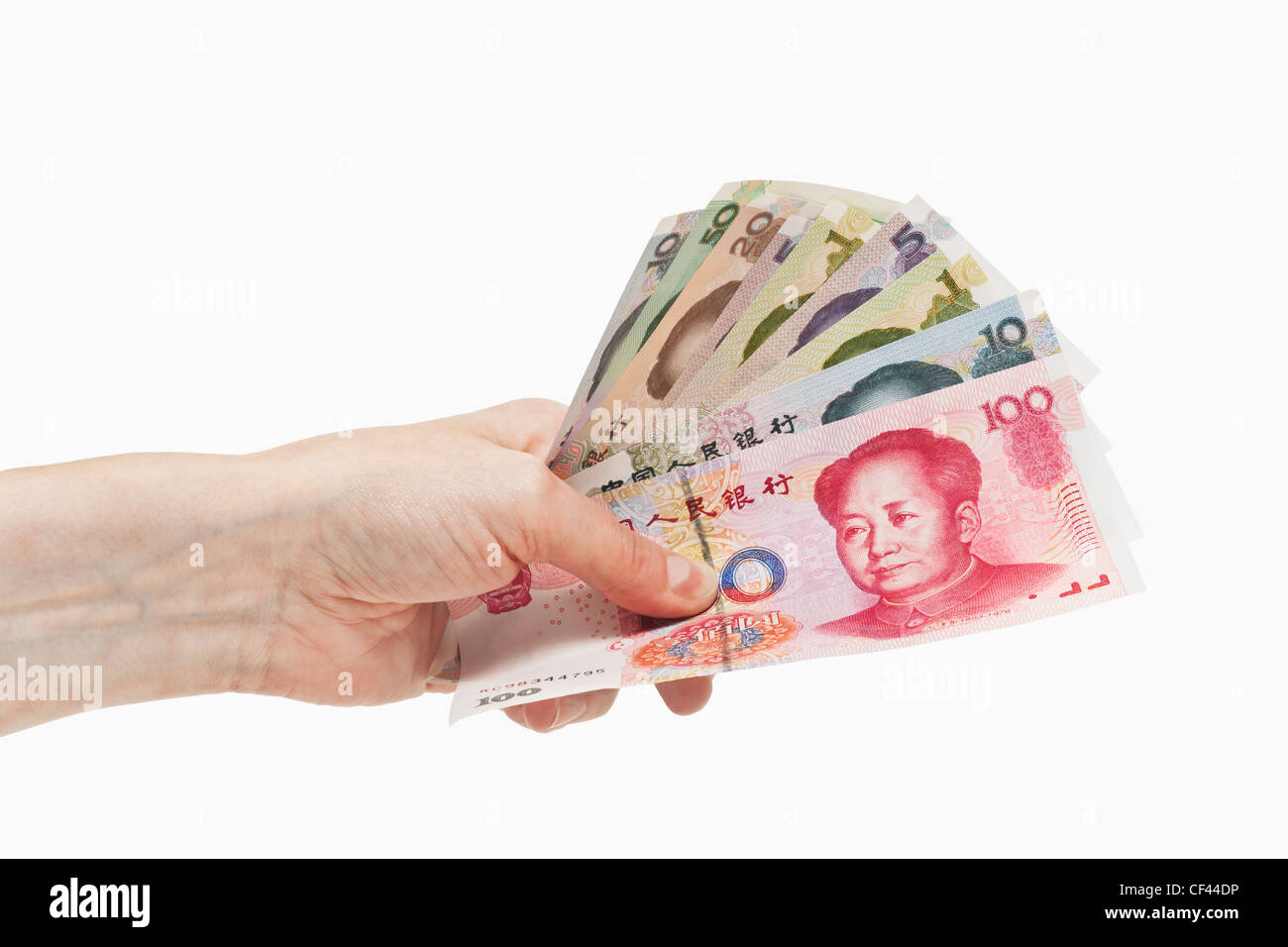Molti diversi yuan cinese fatture con il ritratto di Mao Zedong sono tenute in mano, sfondo bianco. Foto Stock
