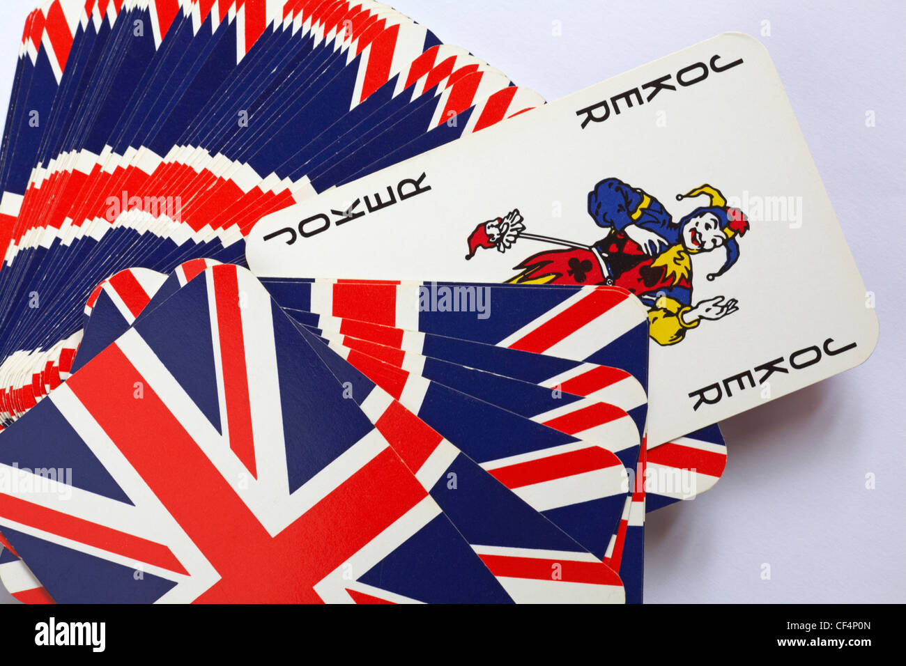 Il jolly del pack ambientato su sfondo bianco: Il jolly in un pacchetto di carte da gioco con i dorsi Union Jack Foto Stock