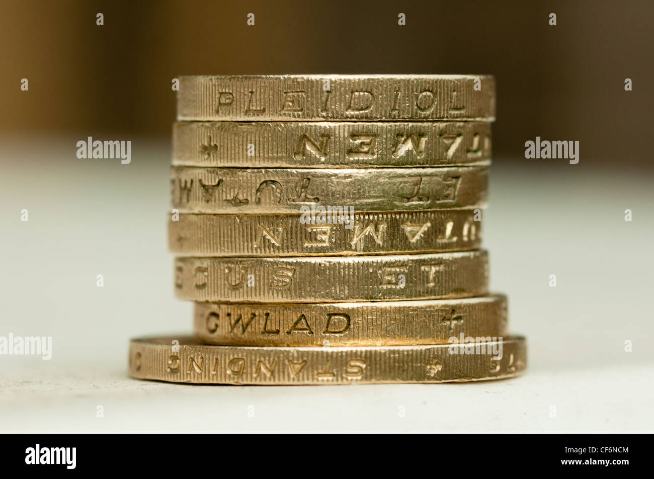 Una pila di una libbra di monete seduto su una due pound coin. Foto Stock