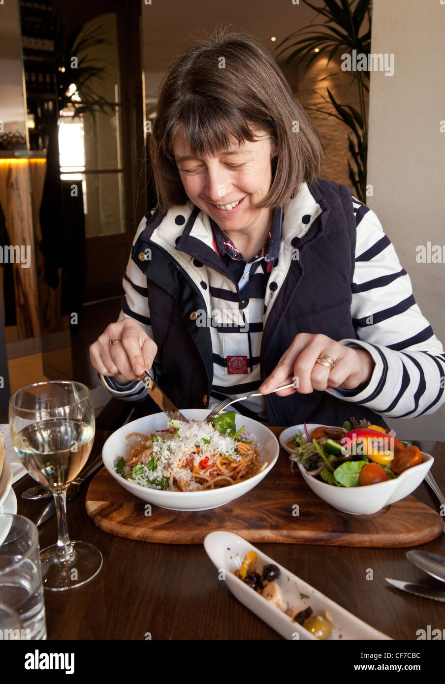 Una donna che mangia un'insalata in un ristorante prezzo, Regno Unito Foto Stock