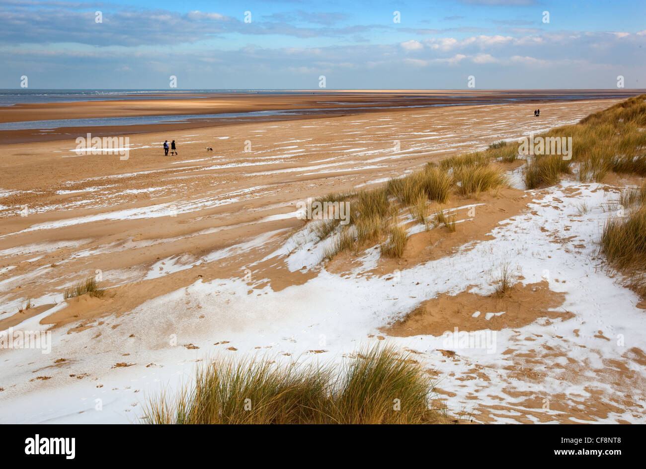 Neve che ricoprono le dune di sabbia e spiaggia a Holkham Bay sulla costa di Norfolk in inverno Foto Stock