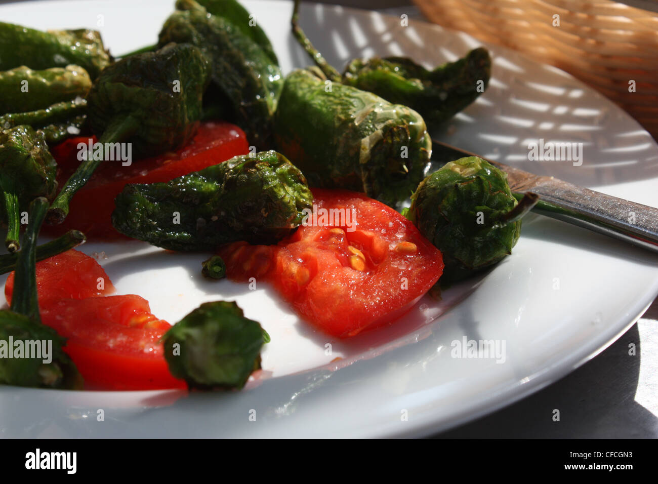 Pimientos de Padrón tapas spagnole i peperoni verdi e pomodori Foto Stock
