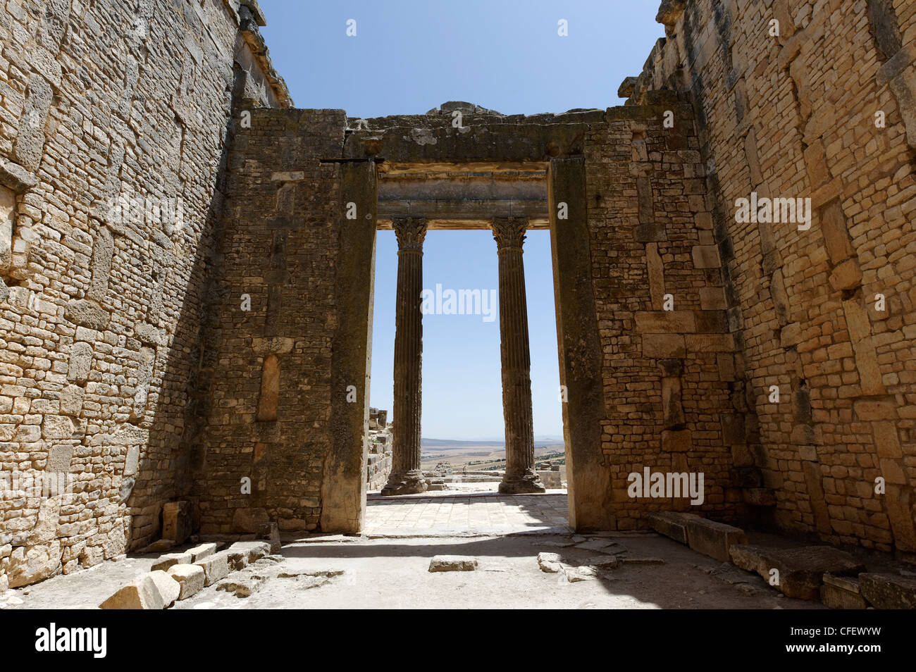 Dougga. La Tunisia. Vista dall'interno del Capitolium attraverso la sua imponente 8 metro di altezza colonne. Risalente al 166 D.C. e Foto Stock