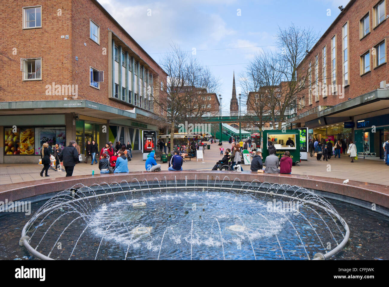 Negozi nel quartiere nel centro della città che guarda verso la vecchia cattedrale guglia, Coventry, West Midlands, England, Regno Unito Foto Stock