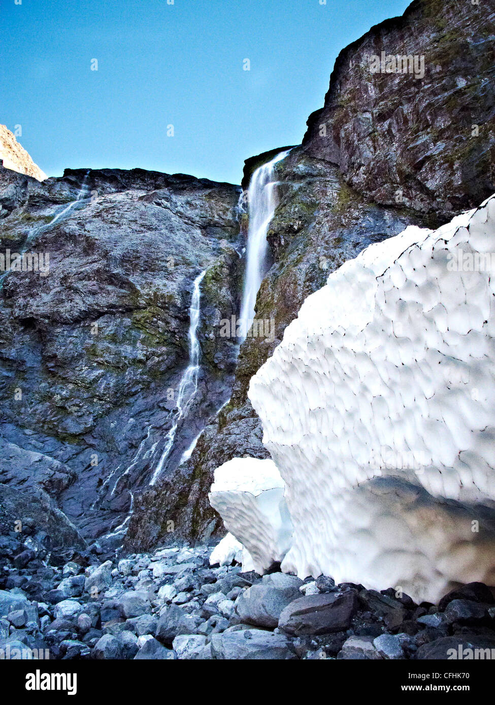 Un ghiacciaio si siede da una caduta di acqua vicino Milford Sound Nuova Zelanda Foto Stock