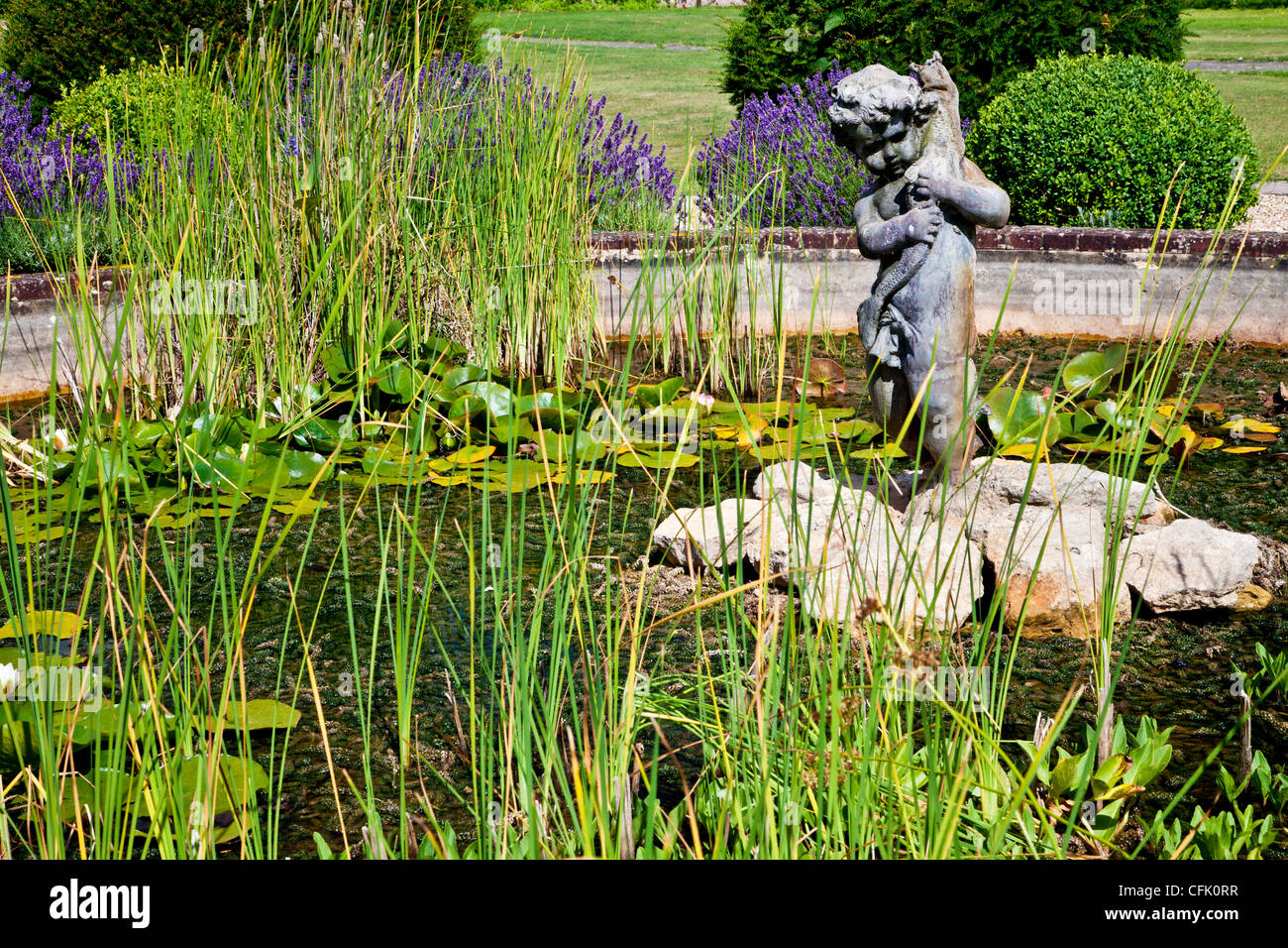 Laghetto ornamentale e statua in inglese il giardino di campagna di Littlecote Manor in Berkshire, Inghilterra, Regno Unito Foto Stock