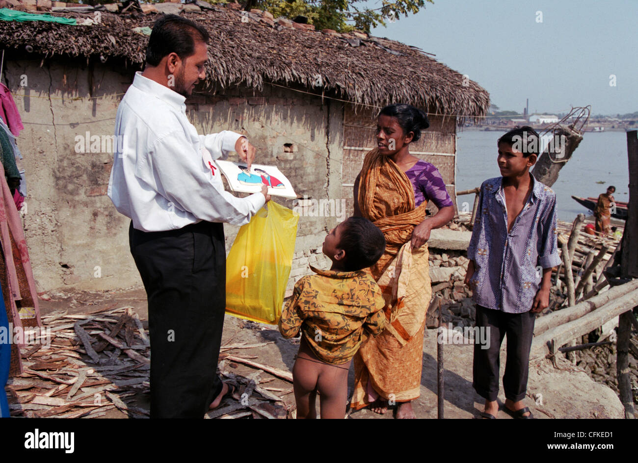 Un uomo che lavora su una campagna di informazione contro il virus HIV e AIDS sulla campagna in Bangladesh. Foto Stock