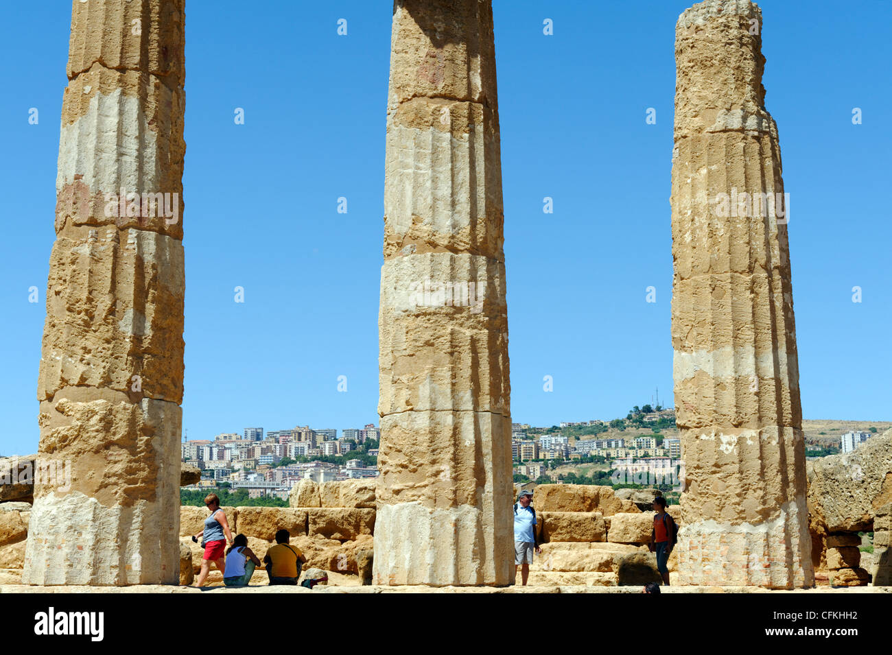 Agrigento. Sicilia. L'Italia. Vista della città medievale di Agrigento attraverso colonne montanti del Tempio di Eracle o Tempio di Foto Stock