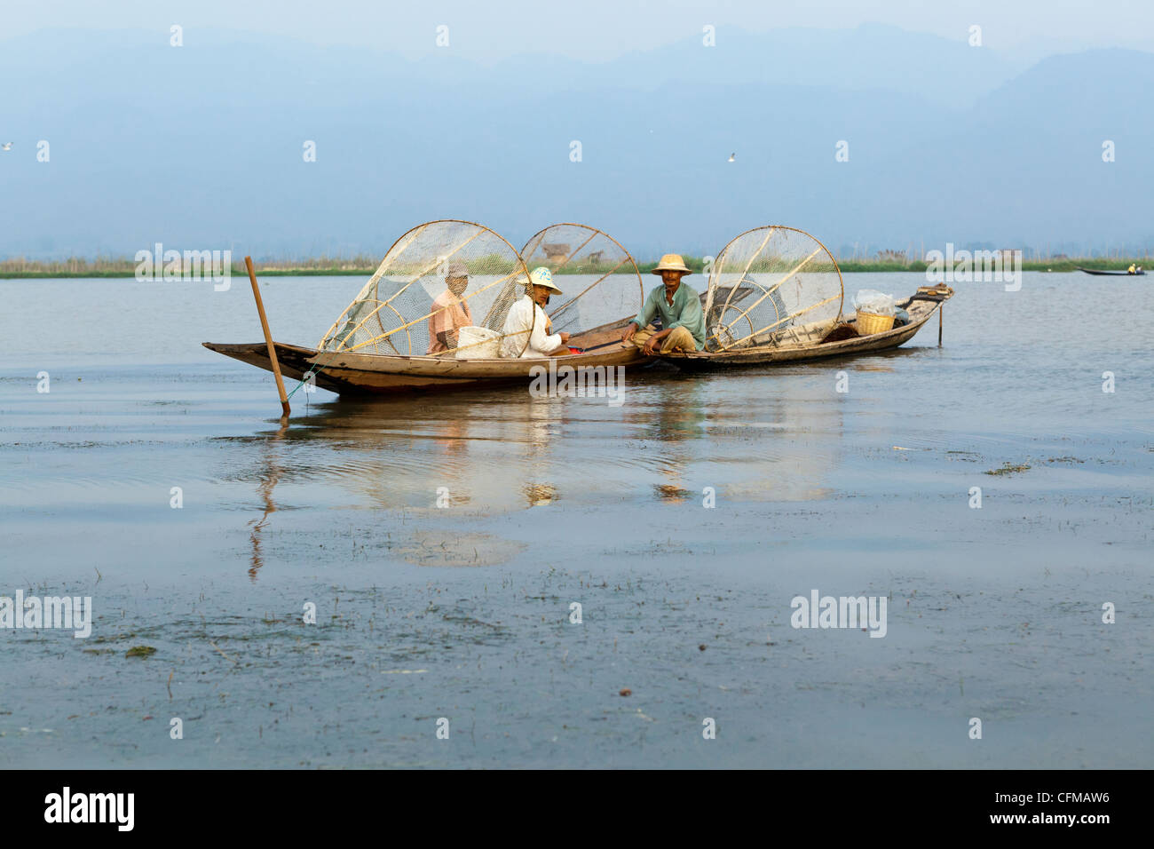 Intha persone che vivono su e intorno al Lago Inle aggirare utilizzando skiffs tradizionale azionato da una singola paletta. Foto Stock