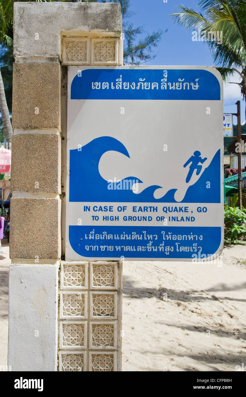 Terremoto Tsunami evacuazione segno che indica di eseguire a terra superiore o di navigazione a Kamala Beach, Phuket, Tailandia Foto Stock
