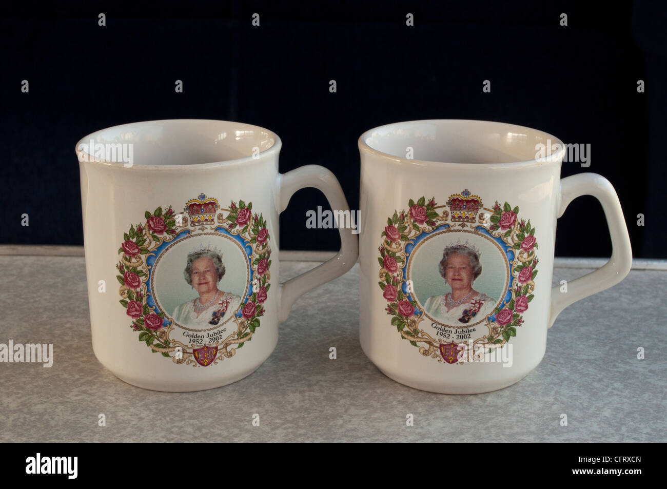 Due letti Queen Elizabeth II Giubileo d oro tazze Commemorative seduto su una formica cafe tabella Foto Stock