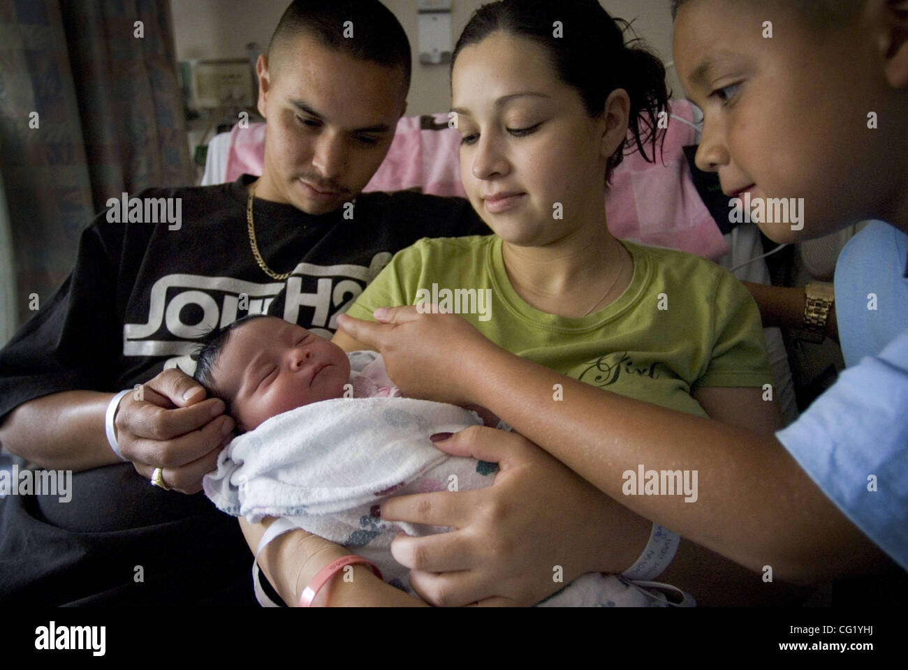 JUMP LEDE - Padre Gregorio Johnson, madre, Rosalina Garcia e al neonato il fratello di Steven Morales, 8, tutti di Sacramento trascorrere del tempo con il suo neonato Lilyanna, a Sutter Memorial Hospital Sacramento Luglio 10, 2007. Rosalina della madre, Irene, videoregistrati la nascita. Area di molti ospedali non sono un Foto Stock