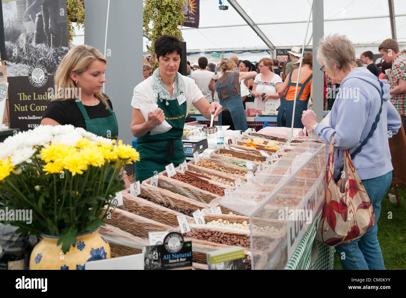 Il dado di Ludlow stallo azienda presenta i propri prodotti ai visitatori a Ludlow Food Festival, Ludlow UK, 8 settembre 2012. Il Ludlow Food Festival è un evento annuale che promuove le aree piccole di alimenti e bevande e i produttori si terrà nel parco del Castello di Ludlow. Foto Stock