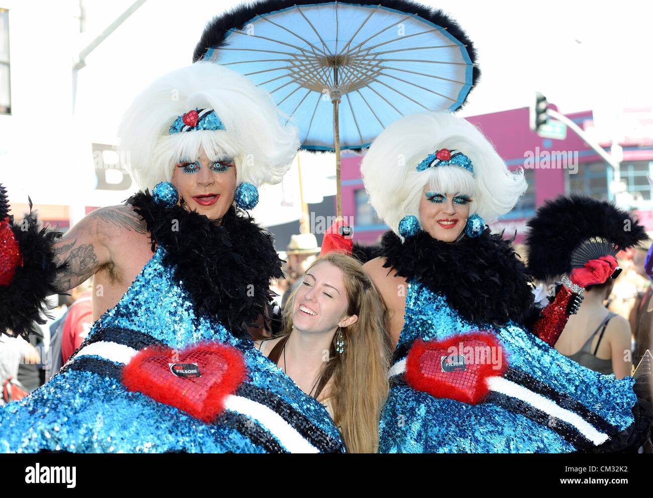 San Francisco, California, Stati Uniti d'America - 23 Settembre 2012: due attraversato vestito uomini posano con una giovane donna alla Folsom St Fiera di San Francisco Foto Stock