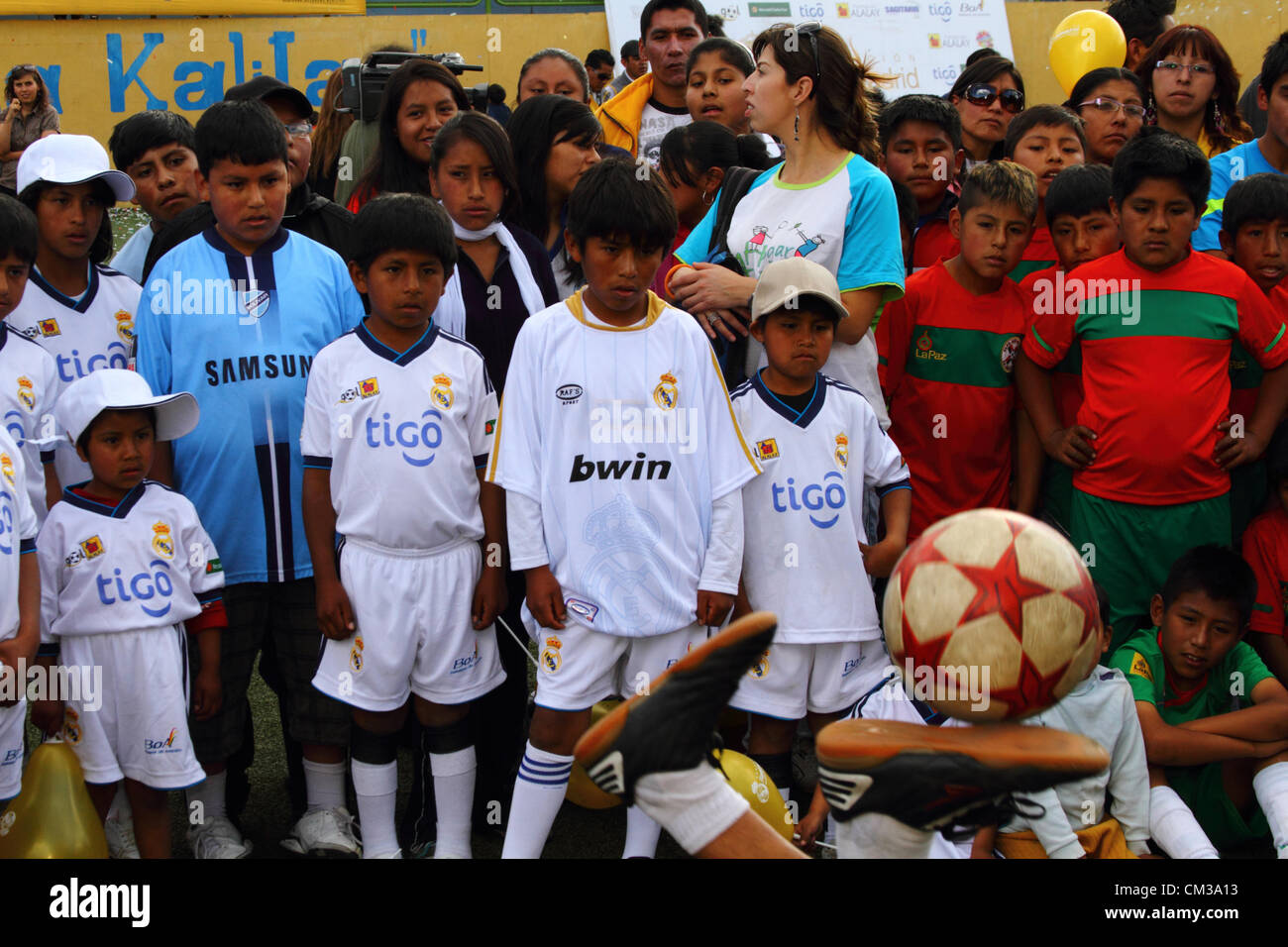 LA PAZ, Bolivia, 24 settembre 2012.I bambini che indossano il Real Madrid shirt godono di una dimostrazione di abilità calcistiche nel corso di una cerimonia di apertura di una scuola sportiva. Il Real Madrid Direttore delle Relazioni Internazionali e ex giocatore Emilio Butragueño ha preso parte alla cerimonia. Il progetto è parte di una campagna dalla Fundación Real Madrid (il ramo sociale del club), collaborando con le autorità locali per fornire altre strutture sportive per bambini da basso reddito aree in Sud America. Foto Stock