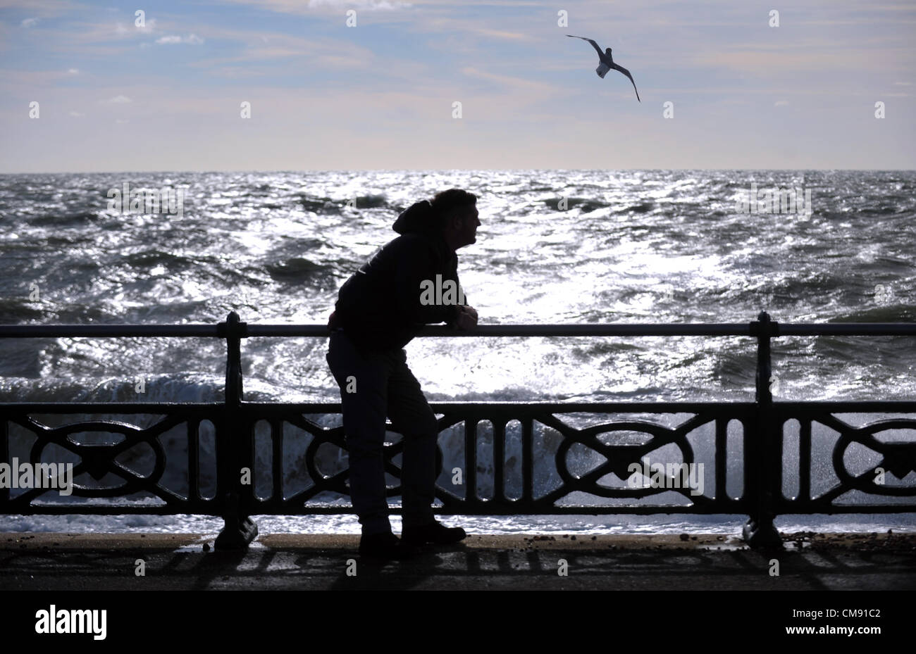 Un giovane che si affaccia al mare come i venti alzarsi sulla costa sud a Hove questo pomeriggio Foto Stock
