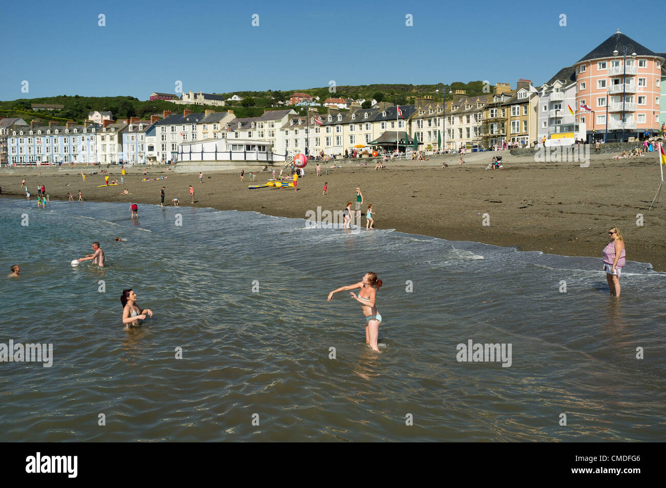 Martedì 24 luglio 2012. Aberystwyth, Wales, Regno Unito. Il clima caldo continua in tutto il Regno Unito con temperature in alta 20s (in gradi celsius). Persone godetevi il sole sulla spiaggia ed in mare in questo Welsh resort costiero. Foto Stock