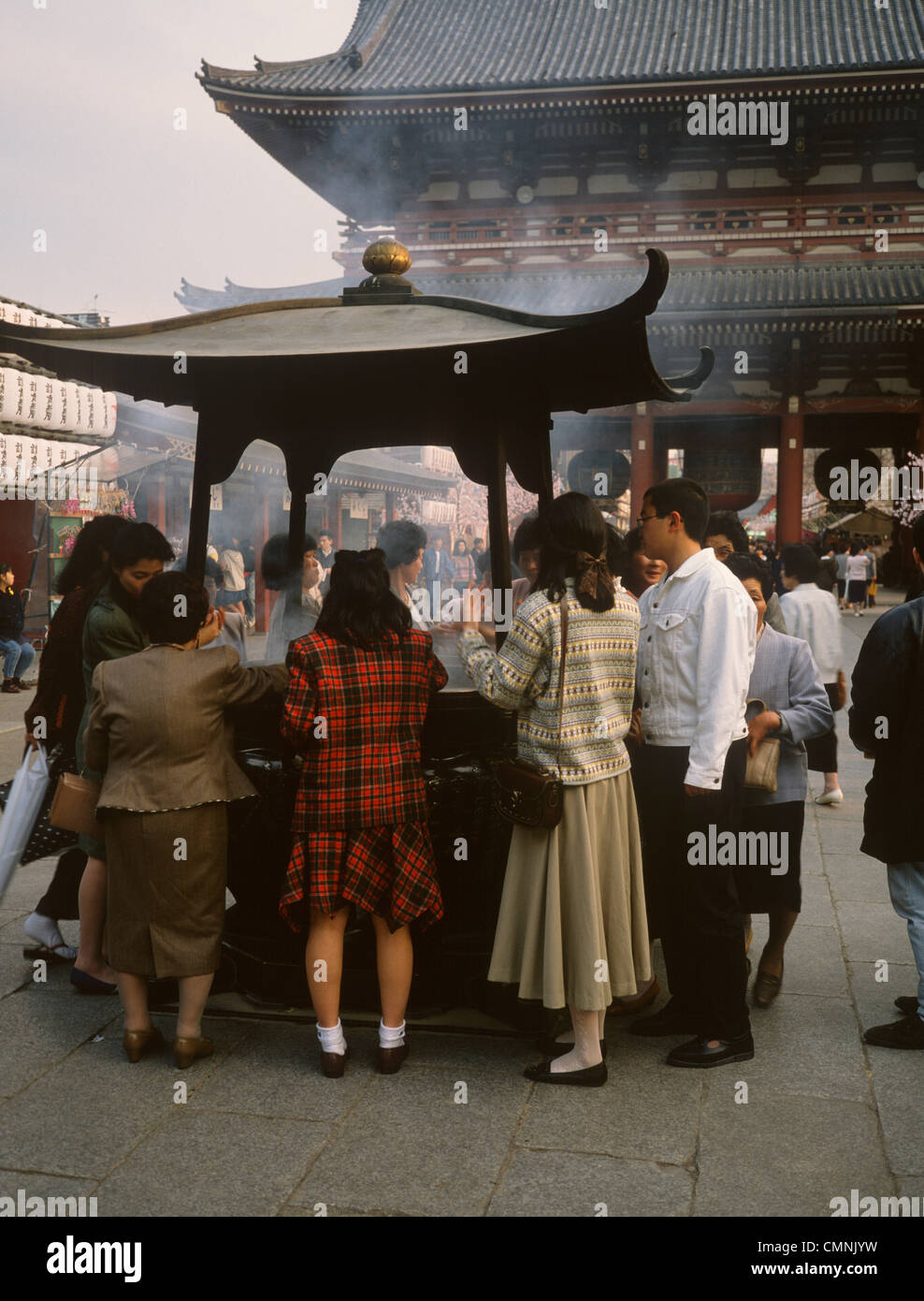 Giappone Tokyo Tempio di Asakusa Kannon offrendo incenso e si diffonde il fumo Foto Stock