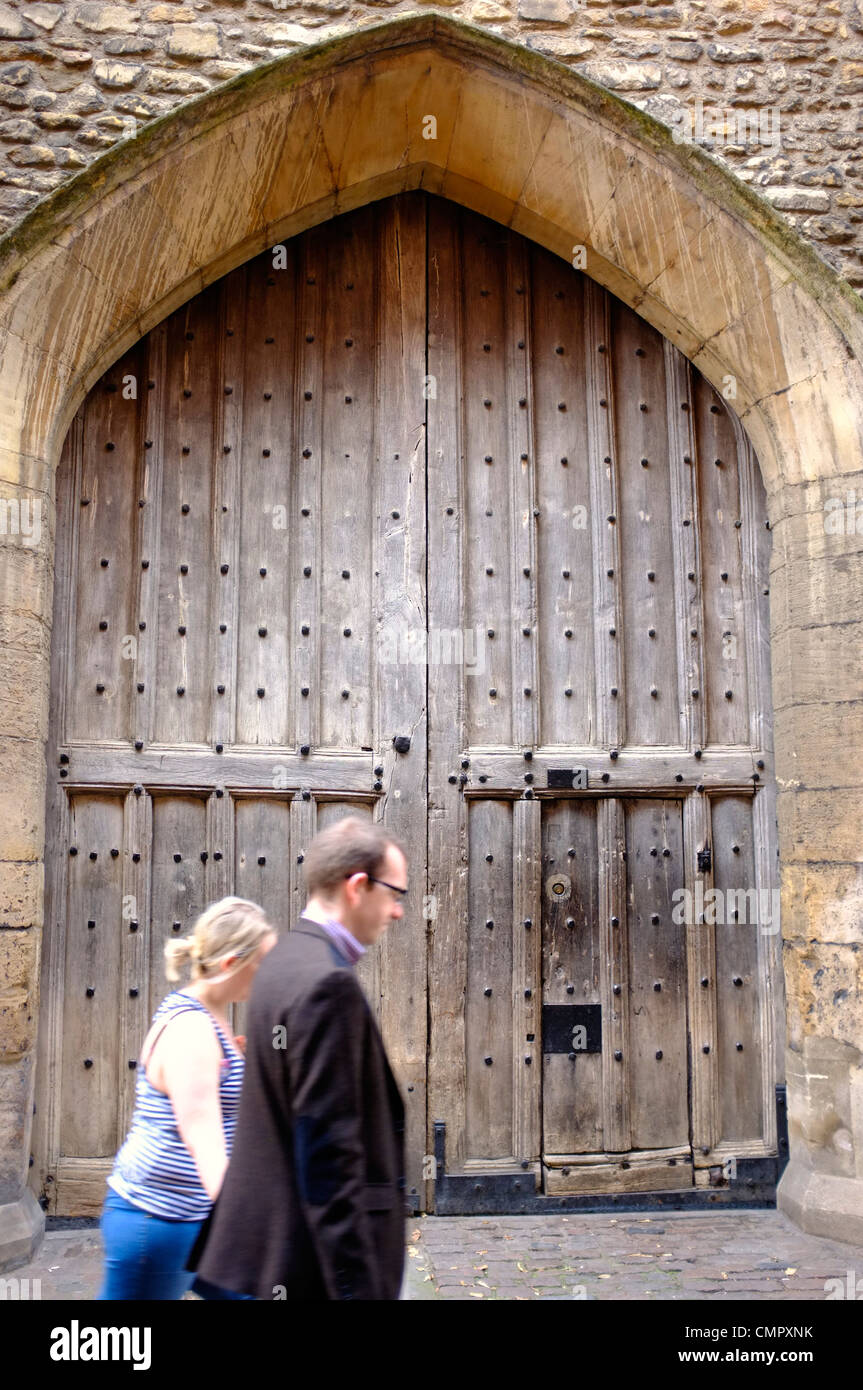 Un giovane oltrepassando una porta medievale Foto Stock