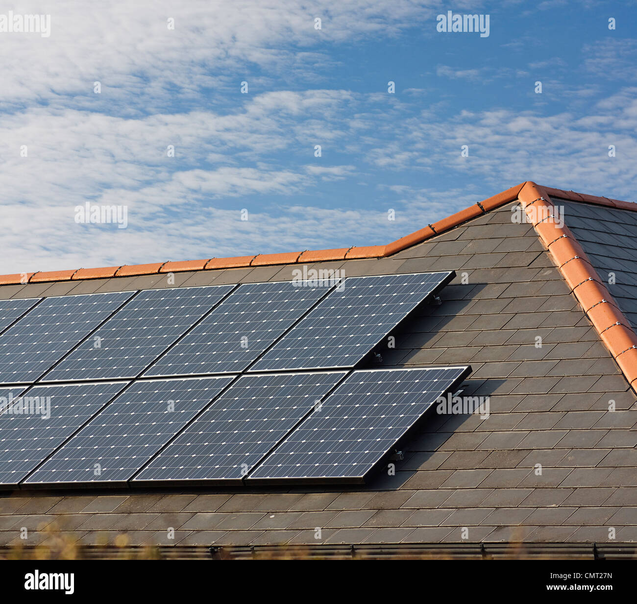 Pannelli solari fotovoltaici montati su un tetto di ardesia di residenziale o casa privata Foto Stock