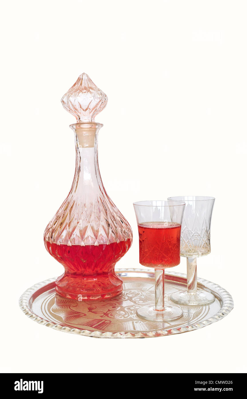 Vintage vino decanter e due bicchieri - uno vuoto e uno riempito con un bicchiere di vino rosso, su lastra d'argento Foto Stock