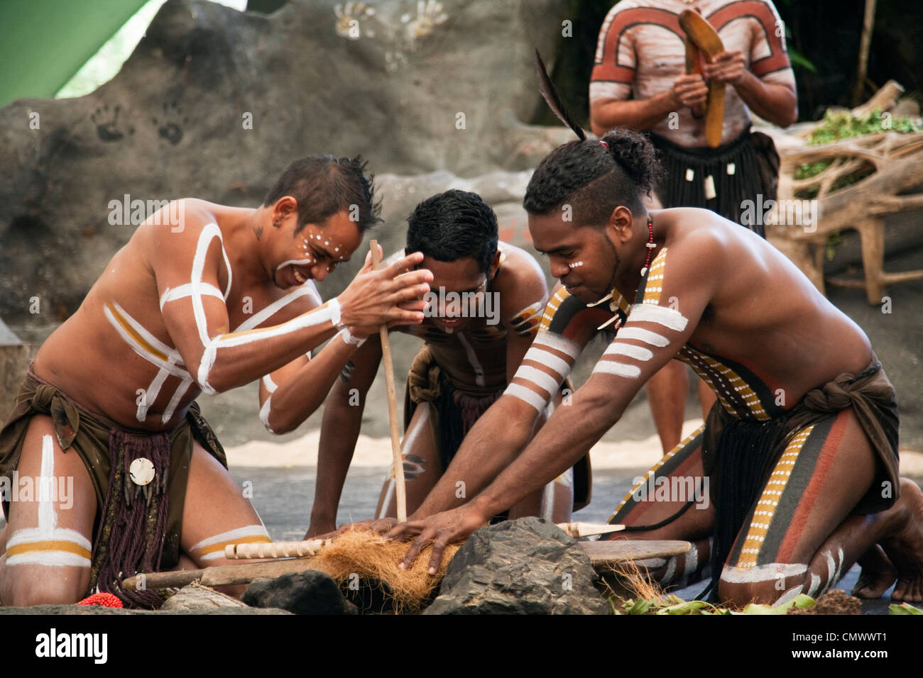 Artisti indigeni utilizzando i metodi tradizionali per fare fuoco. Cairns, Queensland, Australia Foto Stock