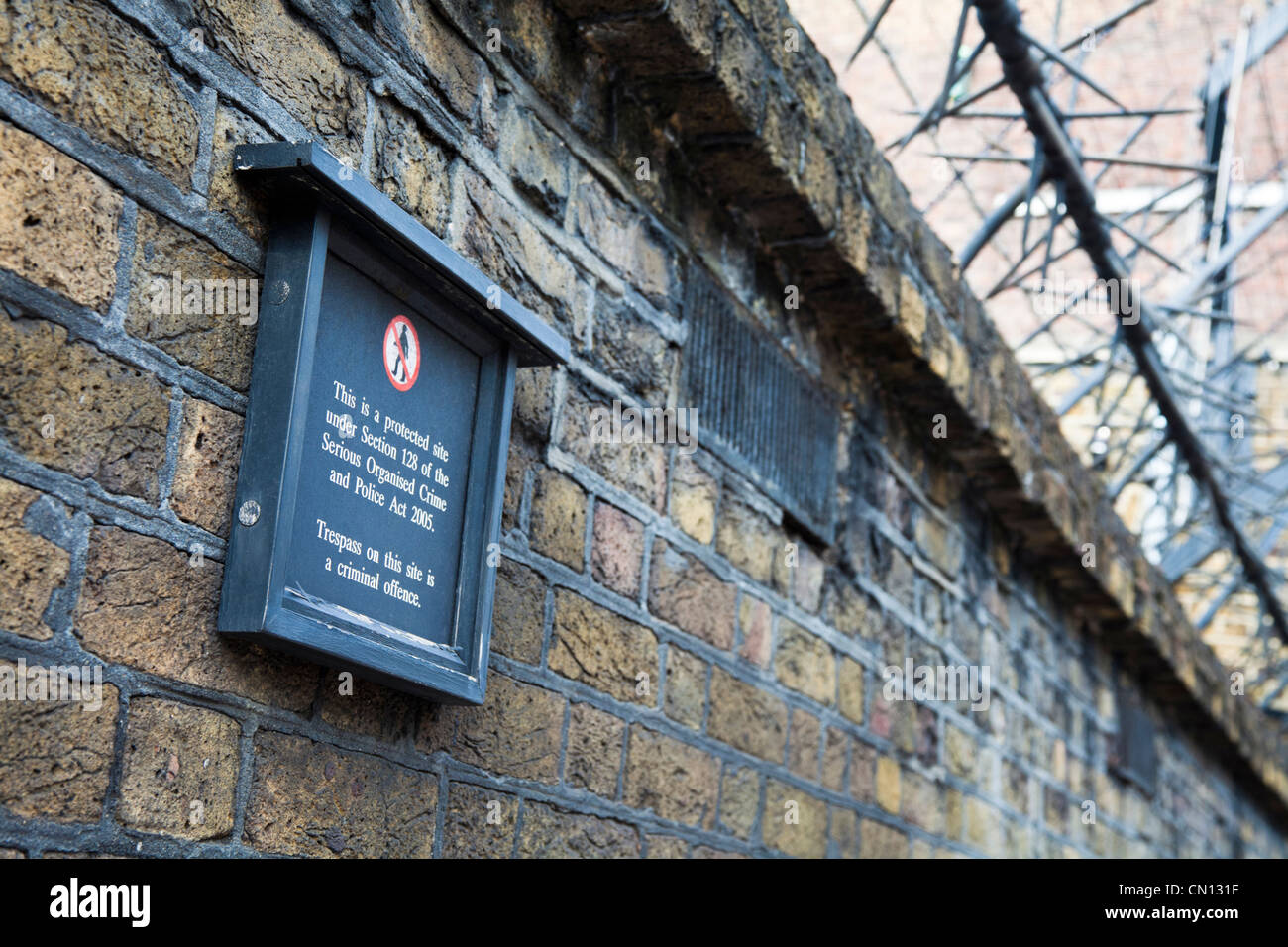 Buckingham Palace - la sicurezza dei picchi di parete e infedeltà segno lungo il muro perimetrale, London, Regno Unito Foto Stock