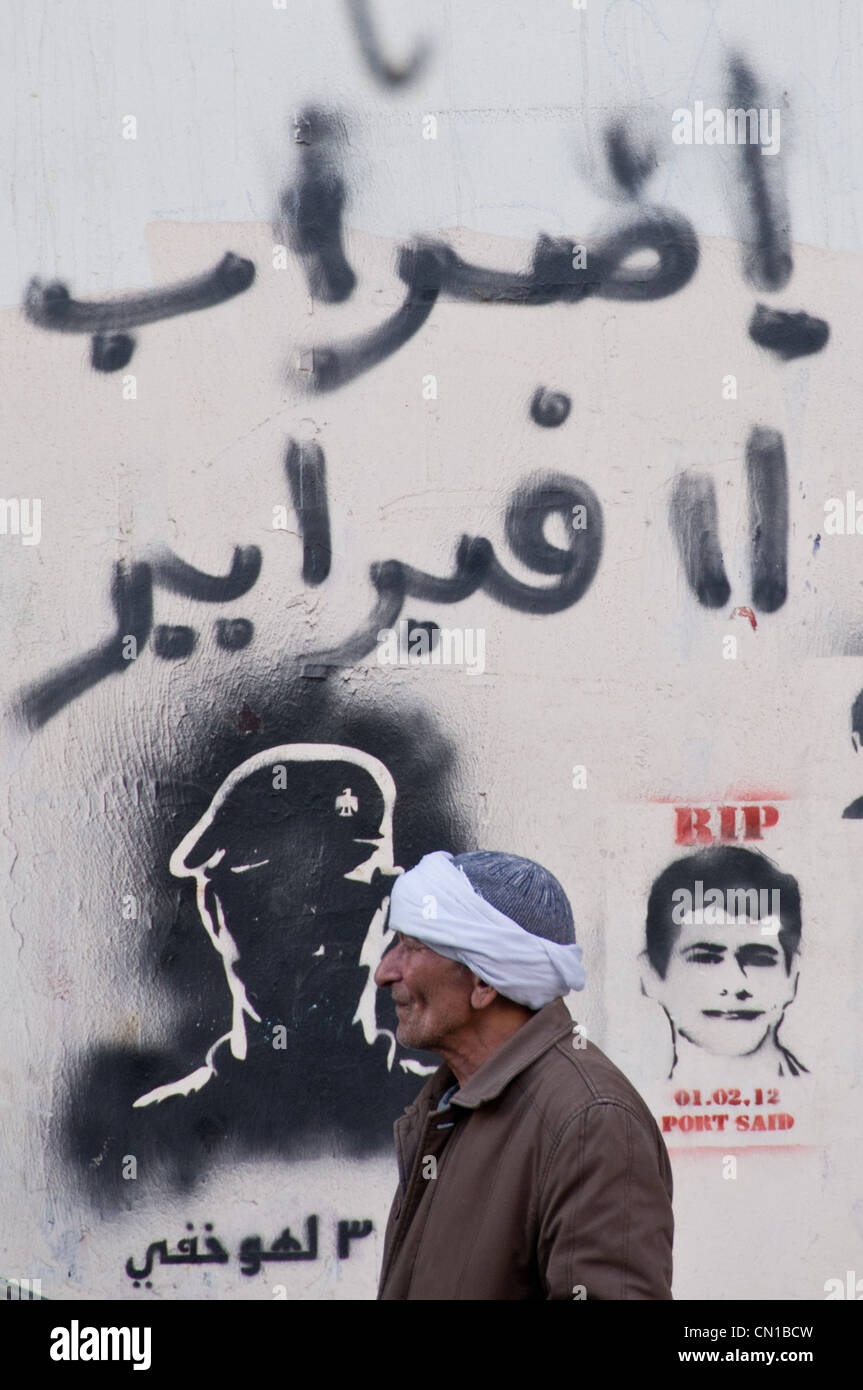 Uomo di fronte a Pro-rivoluzionario murales Heliopolis Cairo, Egitto 2012 Foto Stock