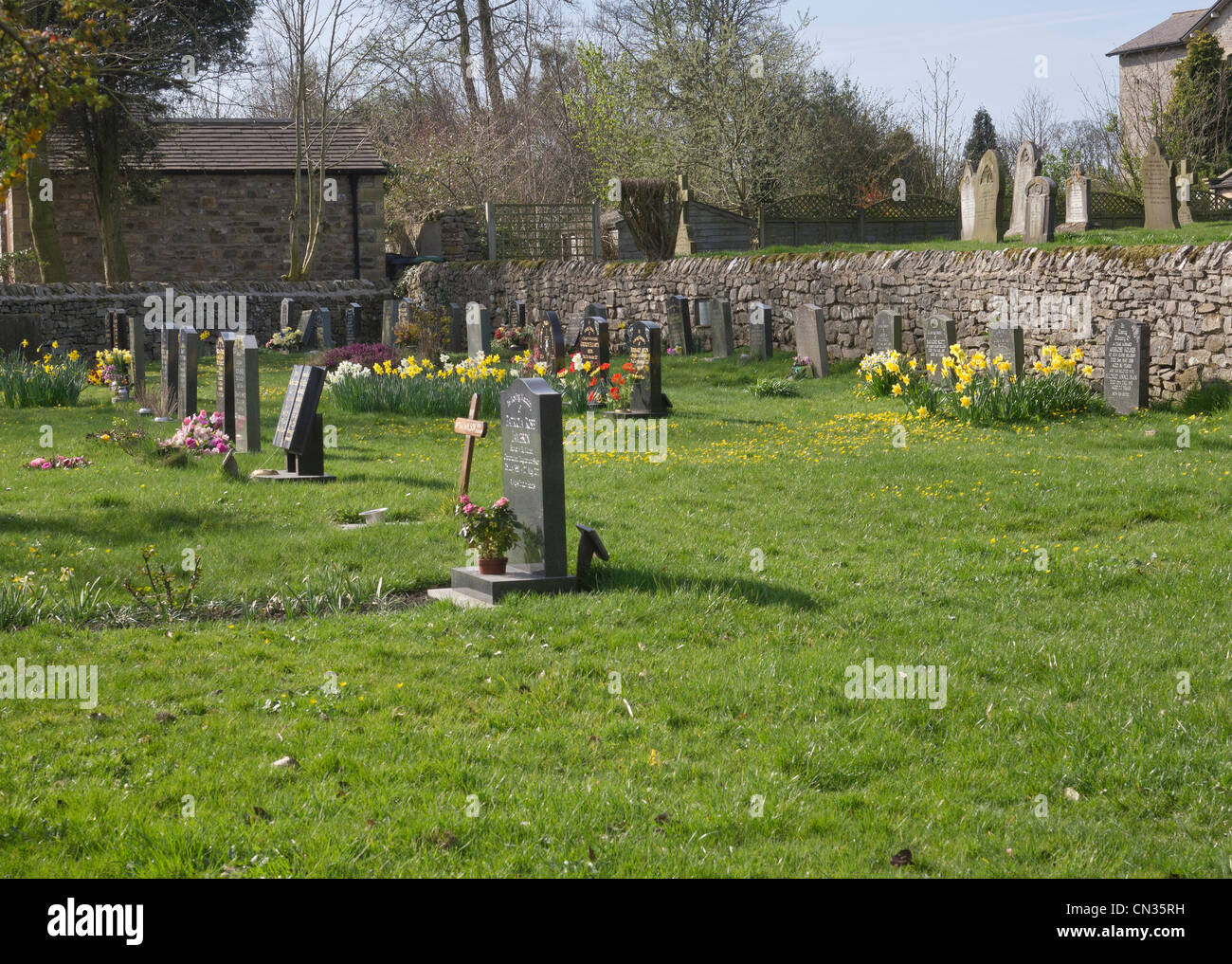 Primavera in un ben conservato cimitero del villaggio. Foto Stock